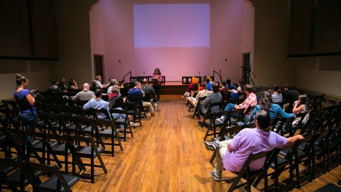 Director Stacey Connelly speaks with cast members in the attic theater before a rehearsal.