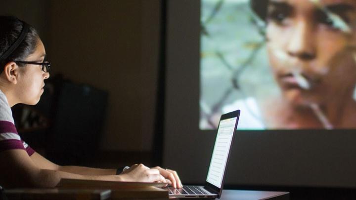 Student Megan Medrano uses her laptop while analyzing a film