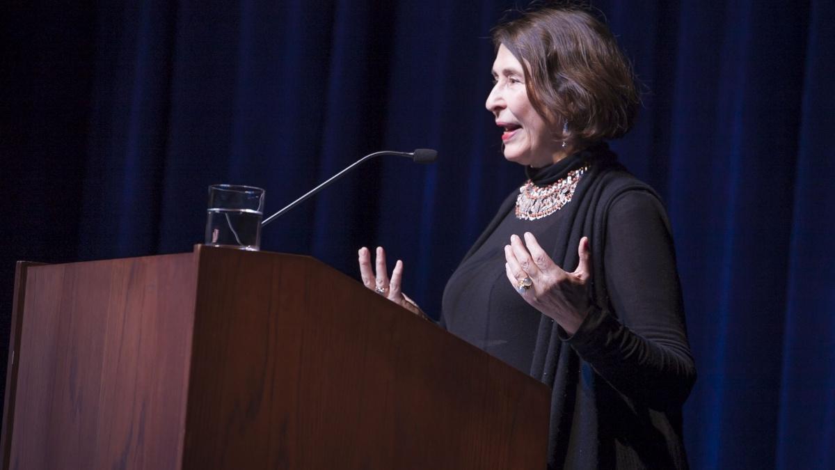 Female giving a lecture at a podium