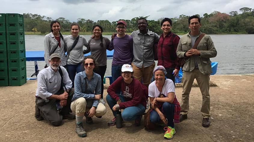 Students gather along a river bank in Nicaragua