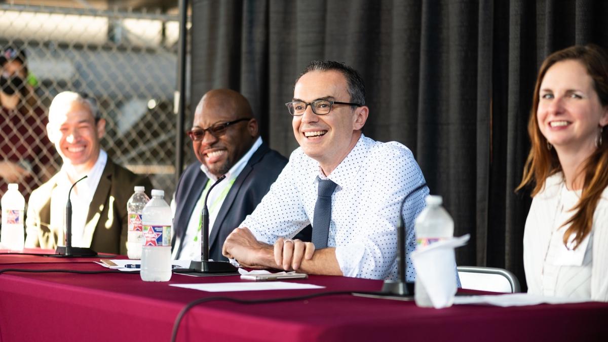 photo of faculty and alumni sitting at a table at a panel discussion